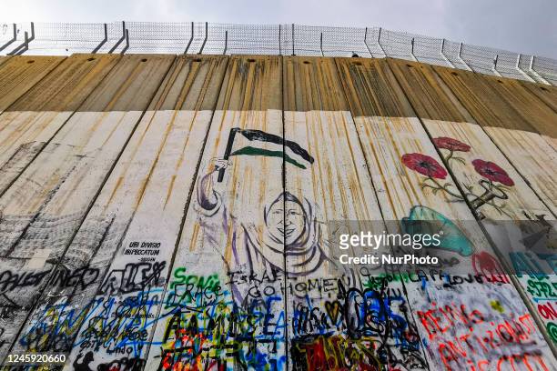 Street art graffiti and murals on the Israeli separation West Bank Wall in Bethlehem, Palestine on December 28, 2022.