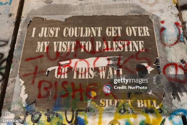 Street art graffiti on the Israeli separation West Bank Wall in Bethlehem, Palestine on December 28, 2022.