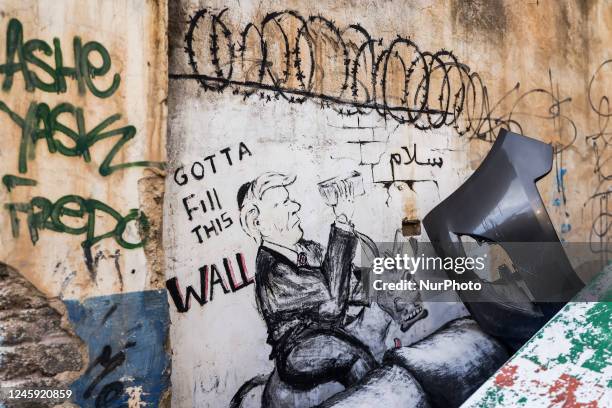 Donald Trump graffiti is seen next to the Israeli separation West Bank Wall in Bethlehem, Palestine on December 28, 2022.