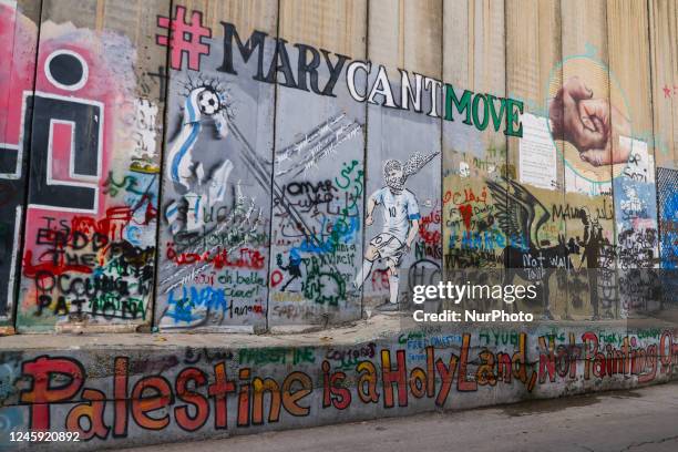 Street art graffiti and murals on the Israeli separation West Bank Wall in Bethlehem, Palestine on December 28, 2022.