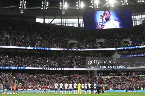 Players and officials observe a minute's applause to honour Brazilian football legend Pele, who died on December 29, ahead of the English Premier...