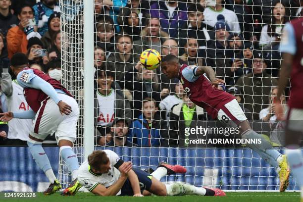 Aston Villa's English defender Ashley Young heads the ball off the line, defending a header from Tottenham Hotspur's English striker Harry Kane...