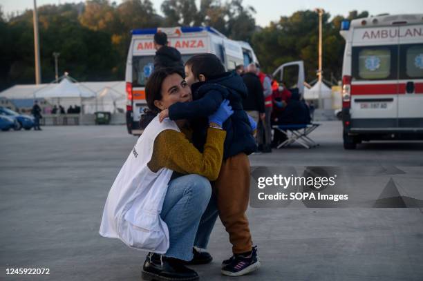 Member of Doctor Without Borders seen holding a child. Nearly 90 migrants, mainly from Afghanistan, Pakistan, and Iran, had been rescued by the...