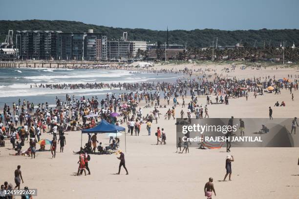 New Year's day revellers and holidaymakers gather on North Beach in Durban on January 1, 2023.
