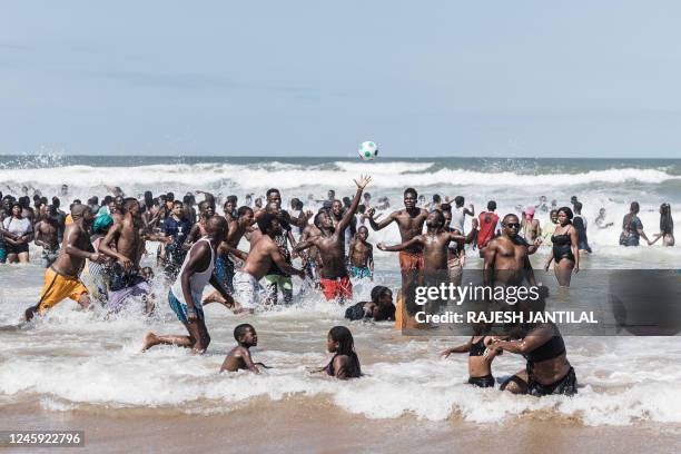 Thousands of New Year's day revellers and holidaymakers gather on the North Beach during New Year festivities in Durban on January 1, 2023. According...