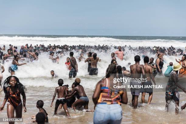 New Year's day revellers and holidaymakers gather on the North Beach in Durban on January 1, 2023.