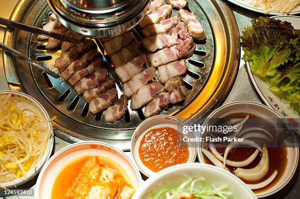 korean barbecue and side dishes - korea stock-fotos und bilder