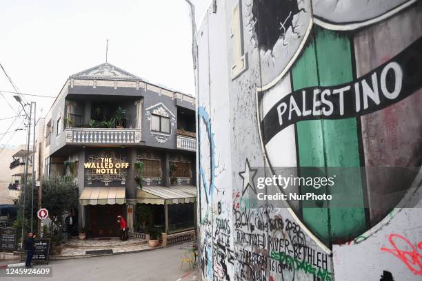 View of 'The Walled Off Hotel' created by Banksy and the Israeli West Bank Barrier in Bethlehem, Palestinian Territories on December 28, 2022.