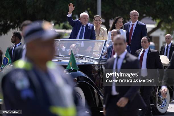 Brazil's President-elect Luiz Inacio Lula da Silva waves to supporters accompanied by his wife Rosangela da Silva , his Vice-President-elect Geraldo...