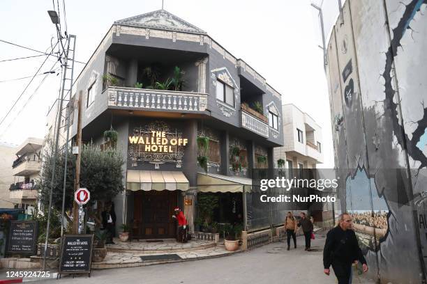 View of 'The Walled Off Hotel' created by Banksy and the Israeli West Bank Barrier in Bethlehem, Palestinian Territories on December 28, 2022.