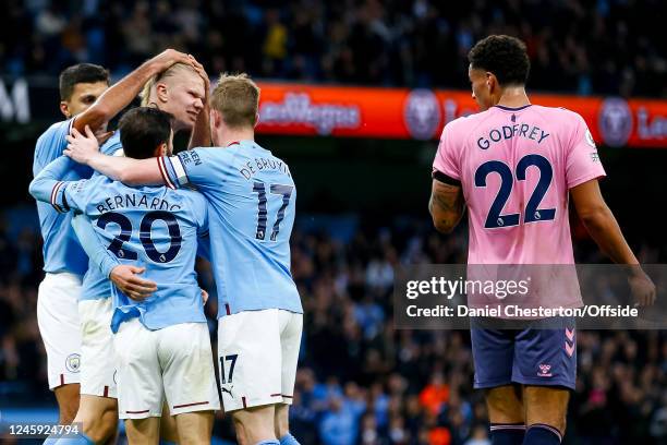 Erling Haaland of Manchester City celebrates in the direction of Ben Godfrey of Everton after scoring their first goal to make the score 1-0 during...