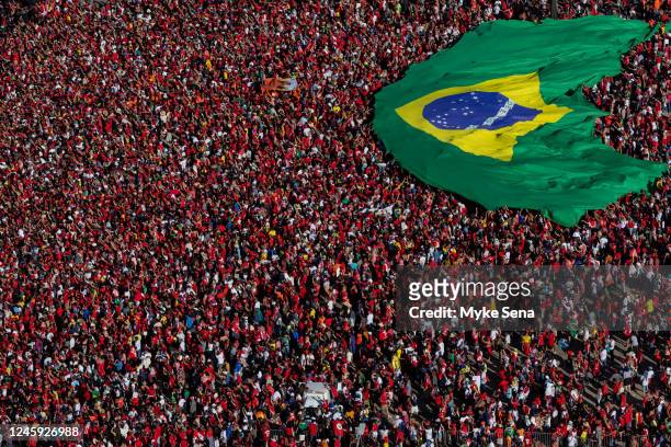 Supporters of President Luiz Inácio Lula Da Silva display a Brazilian flag during the presidential inauguration ceremony at Planalto Palace on...