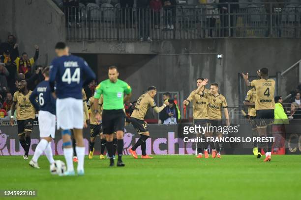 Lens' Polish defender Przemyslaw Frankowski celebrates scoring his team's first goal with teammates during the French L1 football match between RC...
