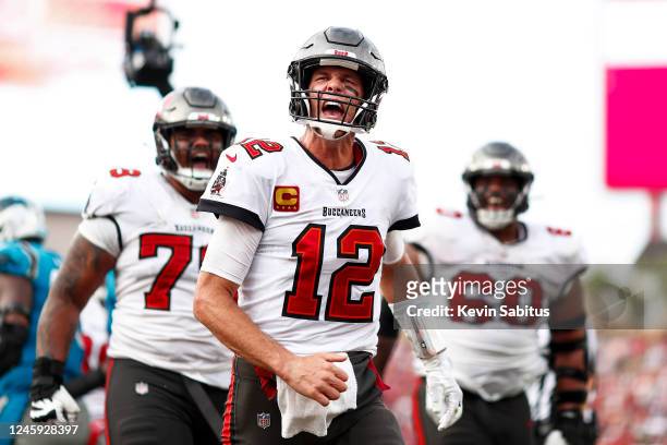 Tom Brady of the Tampa Bay Buccaneers screams in celebration after rushing for a touchdown during the fourth quarter of an NFL football game against...