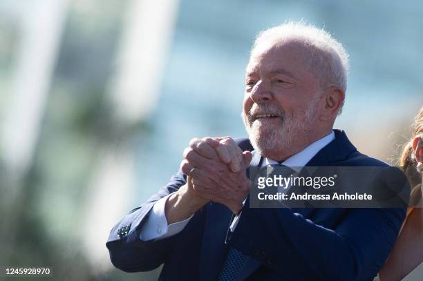 President-elect of Brazil Luiz Inacio Lula da Silva gestures to supporters along as they head towards the National Congress for the presidential...