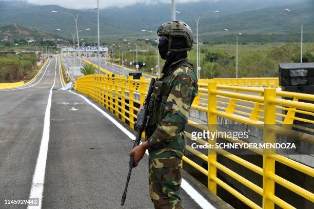 Soldier stands guard at Atanasio Girardot International Bridge -formerly known as Tienditas bridge- which connects Urena in Venezuela with Cucuta in...