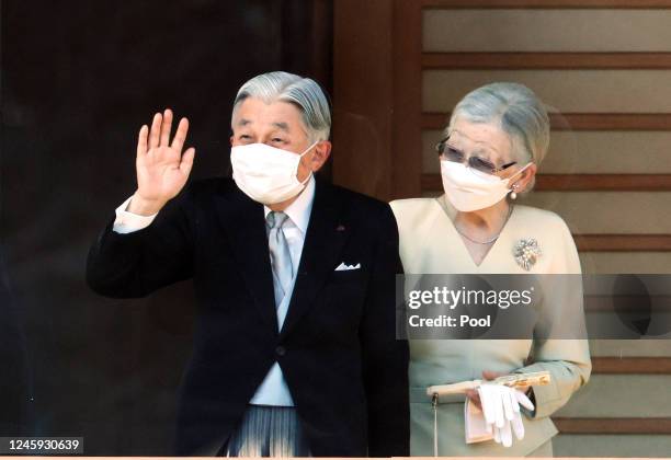 Former Japanese Emperor Akihito and former Empress Michiko wave to well-wishers for the New Year's greetings at the Imperial Palace on January 2,...