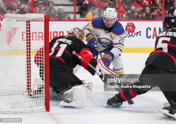 Anton Forsberg of the Ottawa Senators makes a save against Rasmus Dahlin of the Buffalo Sabres at Canadian Tire Centre on January 1, 2023 in Ottawa,...