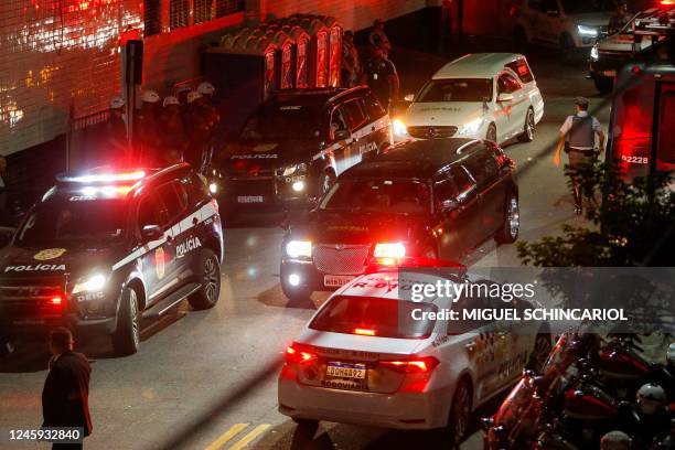 Hearse carrying the coffin of Brazilian football legend Pele arrives at Vila Belmiro stadium as fans mourn his death in Santos on January 2, 2023. -...