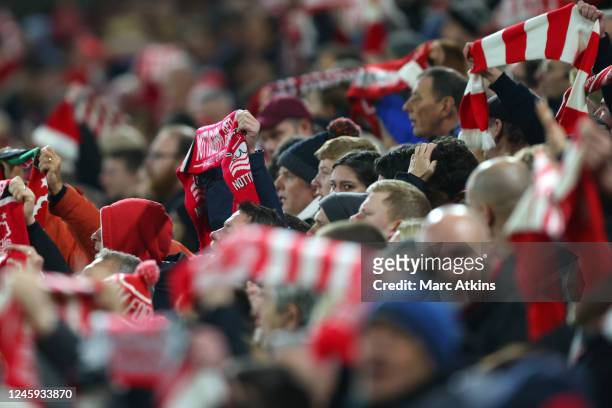 Nottingham Forest fans hold scarves aloft during the Premier League match between Nottingham Forest and Chelsea FC at City Ground on January 1, 2023...