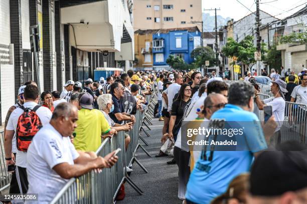 Fans line up to see Pele's tomb in front of the Vila Belmiro Stadium during the Brazilian football legend Pele's funeral ceremony in Santos, Brazil...