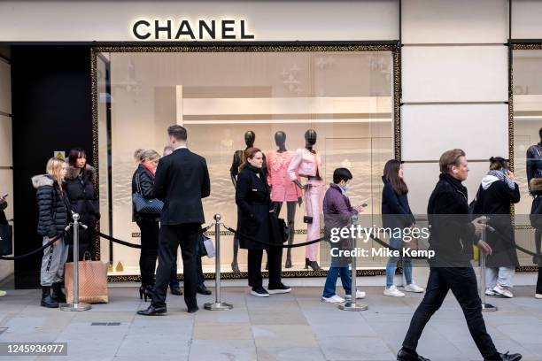 Queue outside Chanel on New Bond Street on 2nd December 2022 in London, United Kingdom. Bond Street is one of the principal streets in the West End...