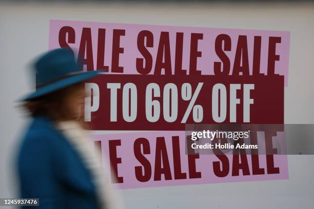 Shopper walks past a sale sign on January 2, 2023 in London, England. 2023 predictions will see inflation in the UK fall but continued rising energy...