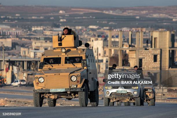 Turkey-backed Syrian fighters deploy in vehicles in al-Bab in the northern rebel-held part of Syria's Aleppo province on January 2, 2022.