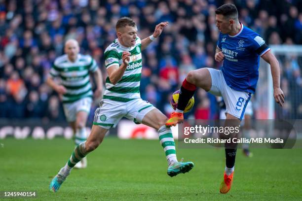 Alistair Johnston of Celtic Ryan Jack of Rangers battle for the ball during the Cinch Scottish Premiership match between Rangers FC and Celtic FC at...