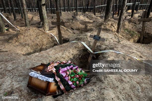 This photograph shows a empty coffin after the exhumation of bodies in the mass graves dug during the Russian occupation in the city of Izium,...