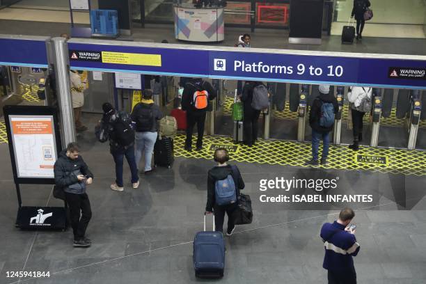 Passengers use Kings Cross station in London, on January 2 ahead of strike action on National Railways this week. - Strikes are planned for this week...