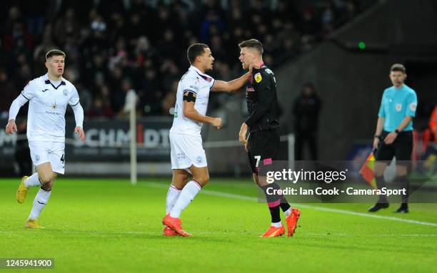 Tempers flare between Swansea City's Joel Latibeaudiere and Burnley's Johann Gu_mundsson during the Sky Bet Championship between Swansea City and...