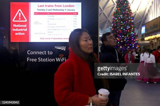 An information screen displays news of the last trains out of London stations, at Kings Cross Station in London, on January 2 ahead of strike action...