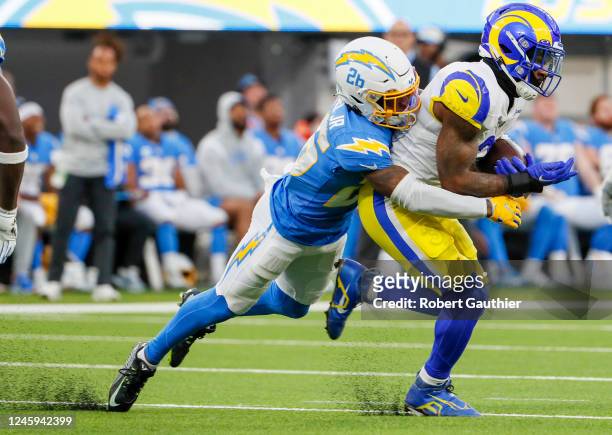Inglewood, CA, Sunday, January 1, 2022 - Los Angeles Rams running back Cam Akers is tackled by Los Angeles Chargers cornerback Asante Samuel Jr. At...