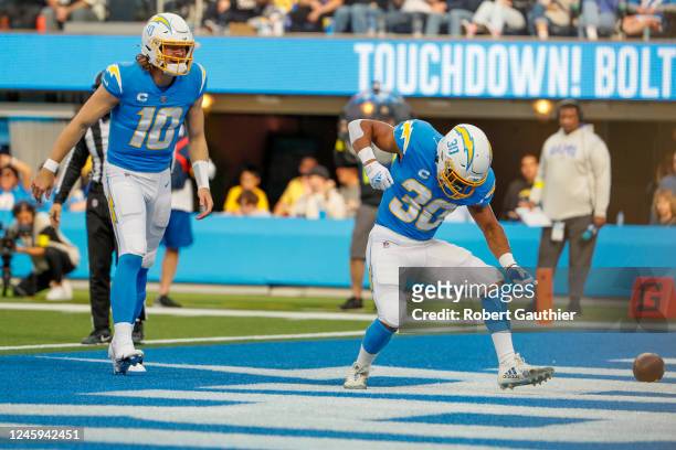 Inglewood, CA, Sunday, January 1, 2022 - Los Angeles Chargers running back Austin Ekeler celebrates with quarterback Justin Herbert after scoring a...