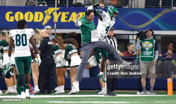 JhaQuan Jackson of the Tulane Green Wave celebrates with wide receivers coach John McMenamin after scoring a touchdown against the USC Trojans in the...