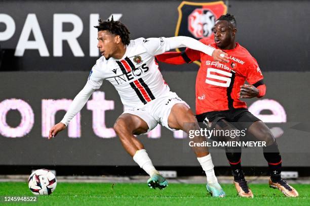 Nice's French defender Jean-Clair Todibo fights for the ball with Rennes' Belgian forward Jeremy Doku during the French L1 football match between...