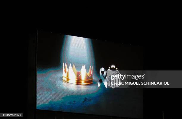 Crown and the logo of Brazilian team Santos are projected on a screen at the Urbano Caldeira stadium, also known as Vila Belmiro, during the wake of...