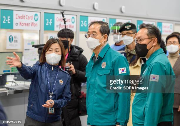 South Korean Prime Minister Han Duck-soo inspects a COVID-19 testing station at Incheon International Airport, west of Seoul. South Korea started...