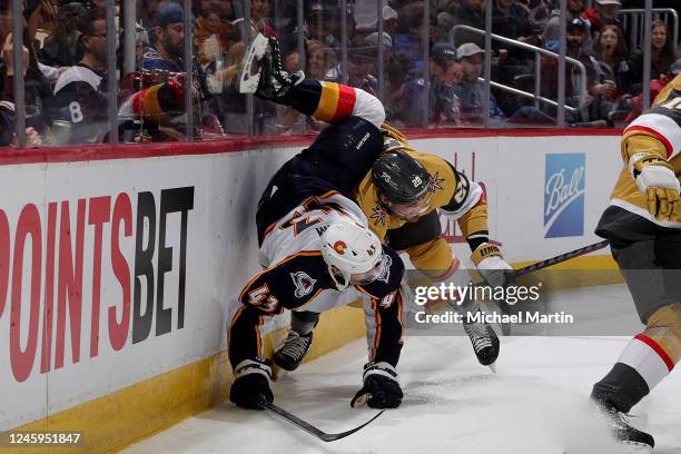 Darren Helm of the Colorado Avalanche collides with William Carrier of the Vegas Golden Knights at Ball Arena on January 2, 2023 in Denver, Colorado.