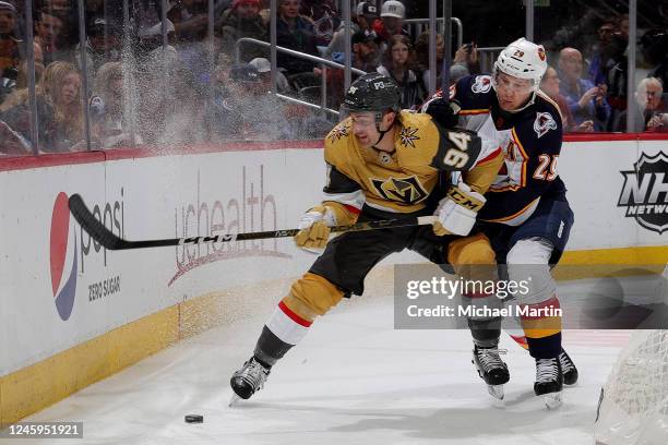 Brayden Pachal of the Vegas Golden Knights skates against Nathan MacKinnon of the Colorado Avalanche at Ball Arena on January 2, 2023 in Denver,...