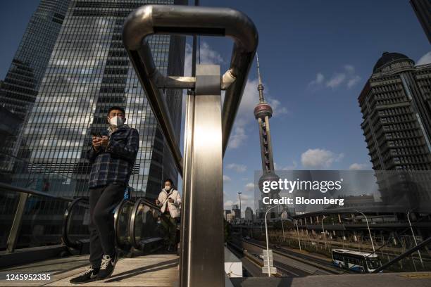 Pedestrians in Pudong's Lujiazui Financial District in Shanghai, China, on Tuesday, Jan. 3, 2023. China's economy ended the year in a major slump as...