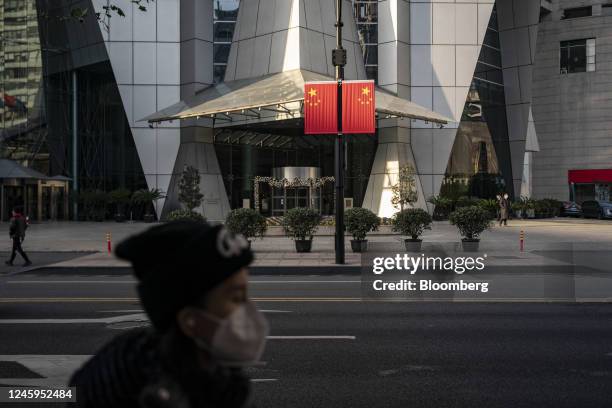 Chinese national flags hang on a lamppost in Shanghai, China, on Tuesday, Jan. 3, 2023. China's economy ended the year in a major slump as business...