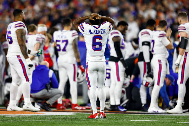 Isaiah McKenzie of the Buffalo Bills reacts to an injury sustained by Damar Hamlin during the first quarter of an NFL football game against the...