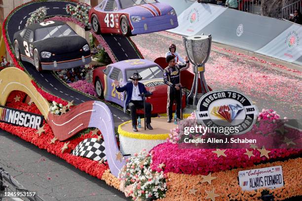 Pasadena, CA Seven-time NASCAR Cup Series champion Richard Petty, left, and up-and-coming racer Rajah Caruth wave to the crowd from the NASCAR float,...