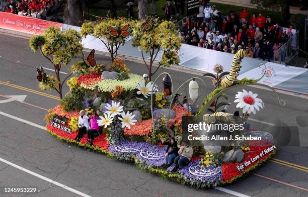Pasadena, CA Thousands of parade-goers watch the City of Torrance For the Love of Nature float during the 2023 Tournament of Roses Parade on Orange...
