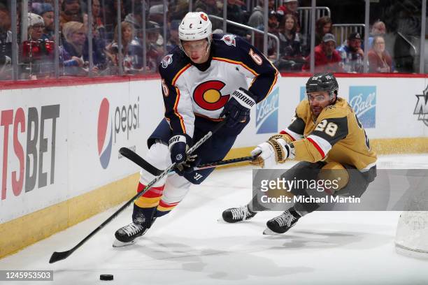 Erik Johnson of the Colorado Avalanche skates against William Carrier of the Vegas Golden Knights at Ball Arena on January 2, 2023 in Denver,...