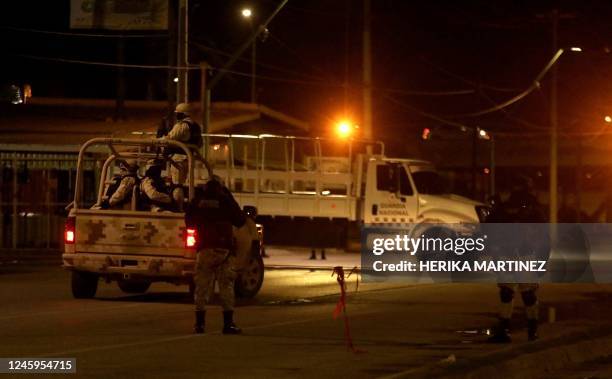 National Guard agents guard the place where tactical equipment and firearms were seized after the murder of two ministerial police officers in Ciudad...