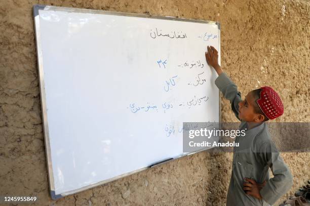 An Afghan student is seen studying in the village of Tormi, which has no school, health center, electricity, heating system, water network and even a...