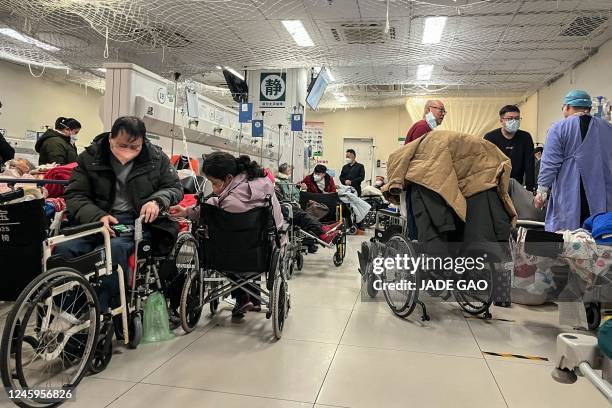 Patients are treated in the emergency department of a hospital in Beijing on January 3, 2023. - Cities across China have struggled with surging...